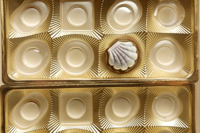 Photo of Partially empty box of chocolate candies as background, top view