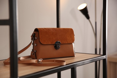Elegant brown bag on shelf in luxury boutique