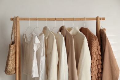 Rack with stylish women's clothes indoors. Modern interior design