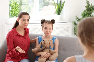 Young mother and her daughter visiting child psychologist in office