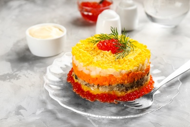 Traditional russian salad Mimosa served on light grey table