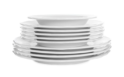 Stack of clean plates on white background