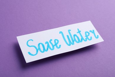 Photo of Card with words Save Water on purple background