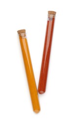 Glass tubes with turmeric and paprika on white background, top view