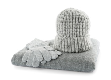 Woolen gloves, hat and scarf on white background. Winter clothes