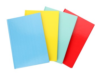 Different colorful hardcover planners on white background, top view
