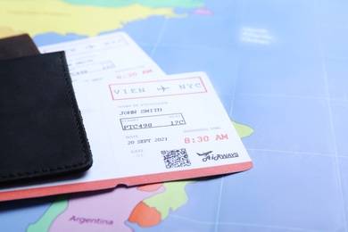 Passports with tickets on world map, closeup. Travel agency concept