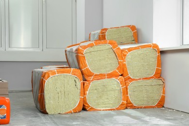 Stacked packages of thermal insulation material in room