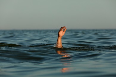 Photo of Drowning man reaching for help in sea