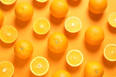 Flat lay composition with ripe oranges on color background
