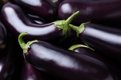 Photo of Fresh ripe purple eggplants as background, closeup