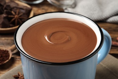 Yummy hot chocolate in mug on table, closeup