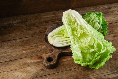 Halves of fresh ripe Chinese cabbage on wooden table