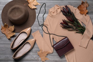 Fall fashion. Layout of women's outfit on wooden background, top view