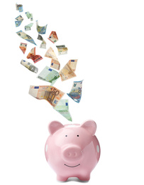 Euro banknotes falling into pink piggy bank on white background