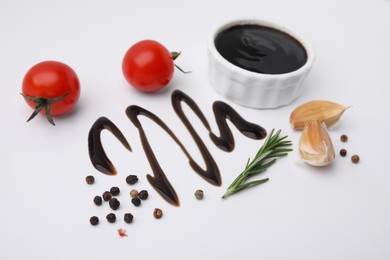 Photo of Organic balsamic vinegar and cooking ingredients on white background