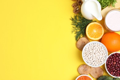 Food high in calcium. Flat lay composition with different products on yellow background, space for text