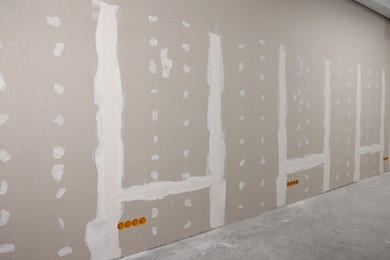 Wall with putty in room. Home renovation
