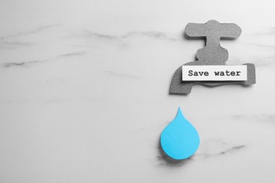 Photo of Paper tap with words Save Water and drop on white table, flat lay. Space for text