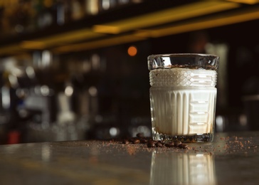 Fresh alcoholic White Russian cocktail on bar counter. Space for text