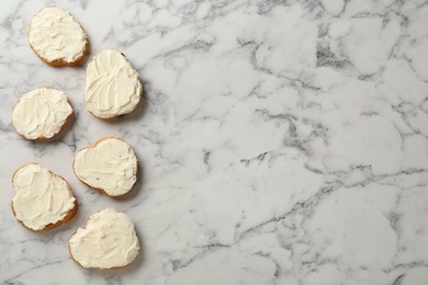 Photo of Delicious sandwiches with cream cheese on white marble table, flat lay. Space for text