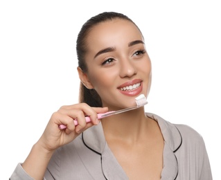 Woman holding toothbrush with paste on white background
