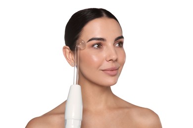 Woman using high frequency darsonval device on white background