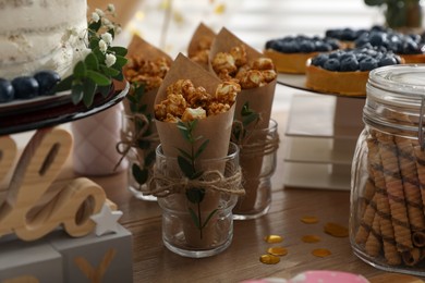 Delicious party treats on wooden table indoors