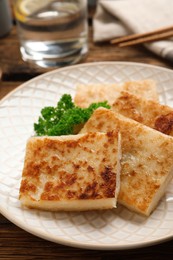 Delicious turnip cake with parsley served on wooden table