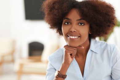 Photo of Portrait of smiling African American woman indoors. Space for text