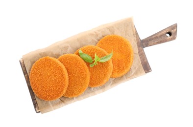 Delicious fried breaded cutlets with basil leaves isolated on white, top view