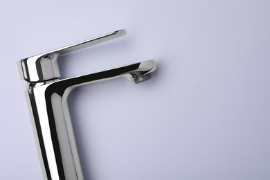 Photo of Single handle water tap on grey background, top view. Space for text