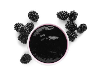 Blackberry puree in bowl and fresh berries on white background, top view