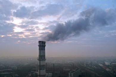 CO2 emissions. Polluting air with smoke from industrial chimney outdoors, aerial view