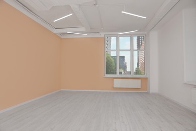 New empty office room with clean windows and beige walls