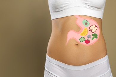 Image of Woman with image of stomach full of food drawn on her belly against beige background, closeup. Healthy eating habits