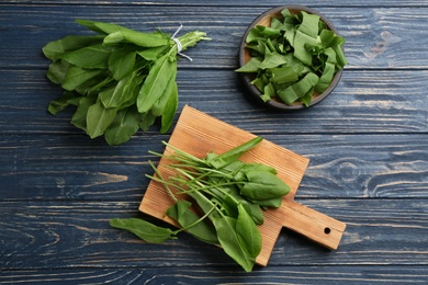 Fresh green sorrel leaves on blue wooden table, flat lay