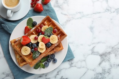 Photo of Delicious Belgian waffles served on white marble table, flat lay. Space for text