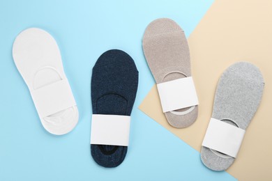 Soft cotton socks on color background, flat lay