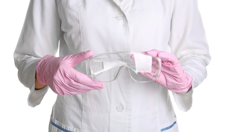 Photo of Doctor in medical gloves with safety glasses on white background