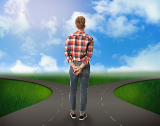 Choose your way. Man standing at crossroads taking important decision
