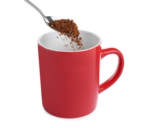 Pouring aromatic instant coffee into red cup on white background