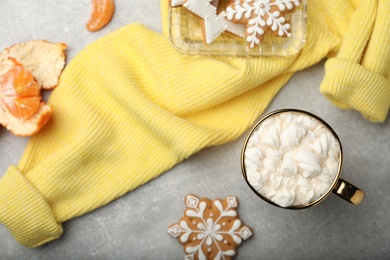 Photo of Flat lay composition with delicious marshmallow drink and yellow sweater on light grey table