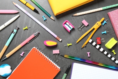 Photo of Flat lay composition with school stationeries on grey background