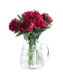 Bouquet of beautiful red peonies in glass jug isolated on white