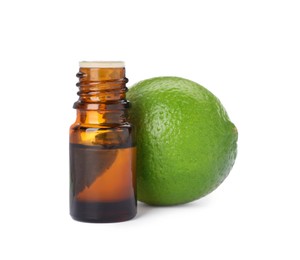 Bottle of citrus essential oil and fresh lime isolated on white