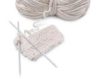 Soft woolen yarn, knitting and metal needles on white background