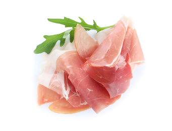 Slices of tasty prosciutto on white background, top view