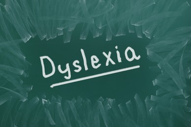 Illustration of Word Dyslexia written on dirty green chalkboard