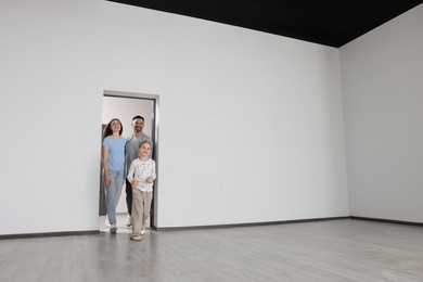 Photo of Happy family entering in their new apartment on moving day. Space for text